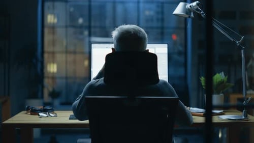 Back view Shot of the Businessman Sitting at His Desk Using Desktop Computer. Stylish Office Studio