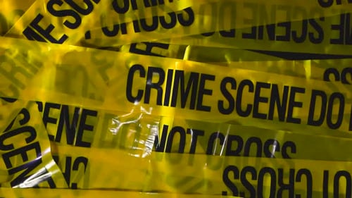 Yellow Crime Scene Tape Layered in Studio With Dramatic Side Light