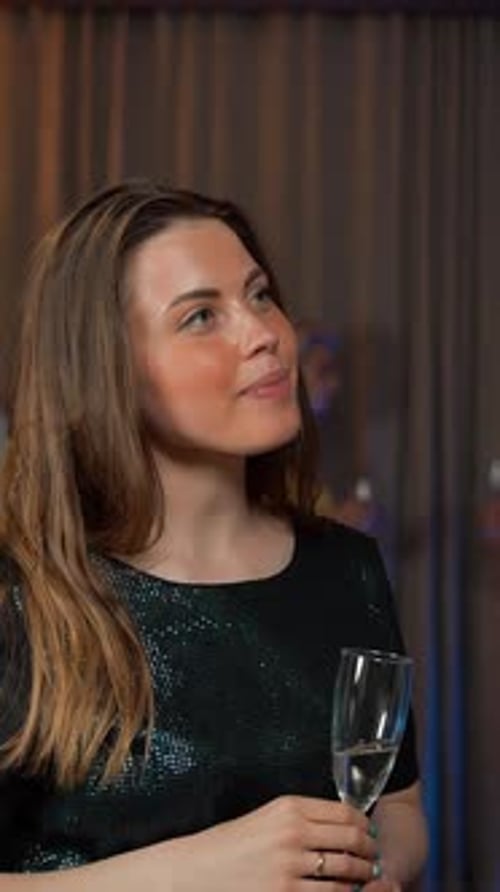 Woman Celebrates with Champagne at Lively Party