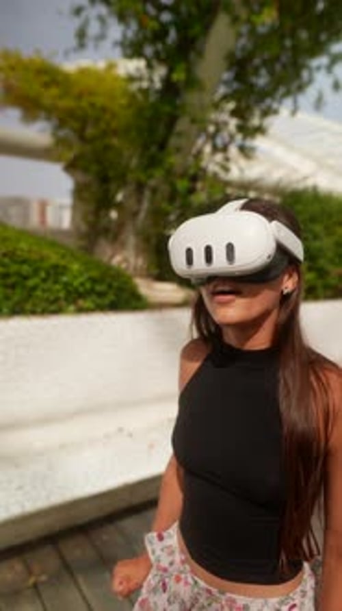 Woman Using VR Headset Outdoors on Sunny Day