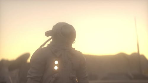 Astronaut on Alien Planet with Hazy Sky at Sunrise