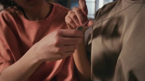 Woman Inspecting Military Dog Tags on Chain