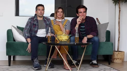 Friends React While Watching TV in Living Room