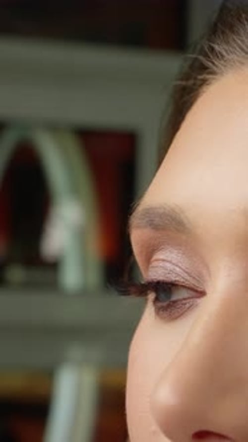 Professional Makeup Artist Carefully Applying Mascara on Fashion Model's Eyelashes During Beauty