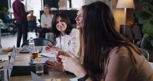 Camera Moves Around Women at Office Table