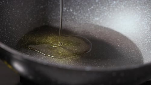 Pouring Oil On a Non-stick Pan. - close up shot