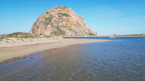 Morro Rock Rising Above Calm Waters and Sandy Shoreline