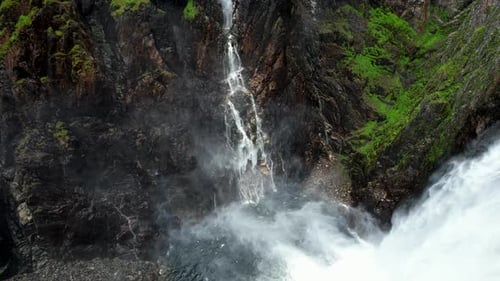 Misty Mountain Waterfall on Rocky Cliff – Voringsfossen Norway