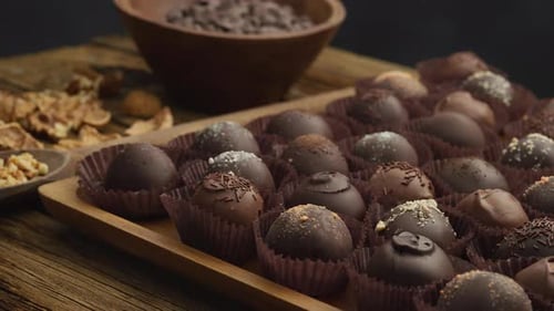 Delicious Chocolate Truffles and Nuts, Wooden Background