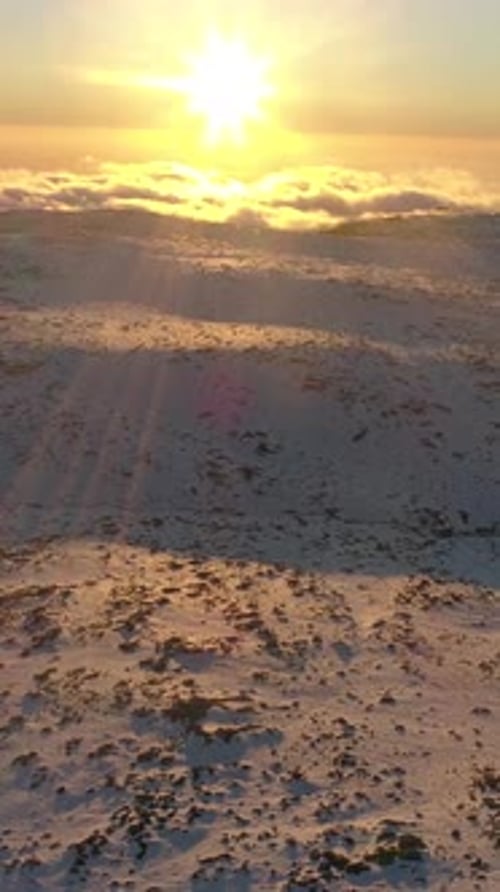 Vertical Video of Snow Mountains at Sunset Aerial