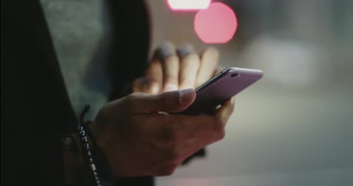 4k video footage of an unrecognizable man using a cellphone in the city