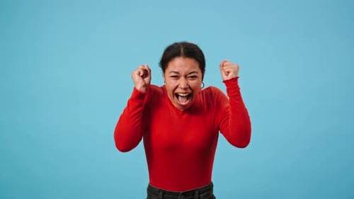 Excited Young Woman Cheering and Celebrating Success