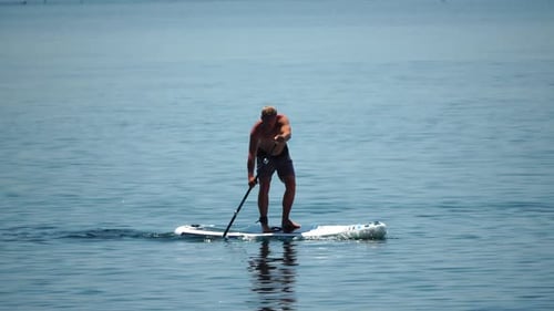Man Sup Sea Strong Athletic Man Learns to Paddle Sup Standing on Board in Open Sea Ocean on Sunny