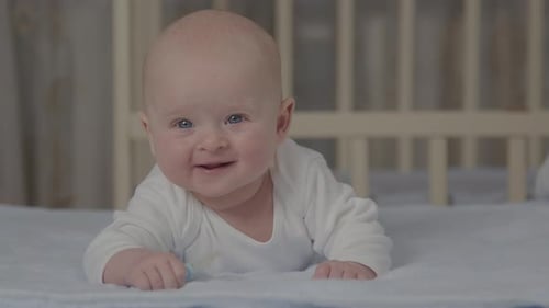 Adorable Baby Lying in Crib Smiling