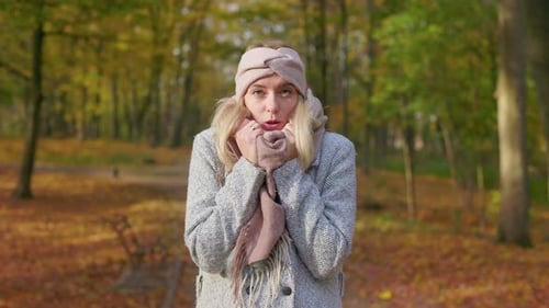 Young Blonde Woman Walking in Park in Cold Weather