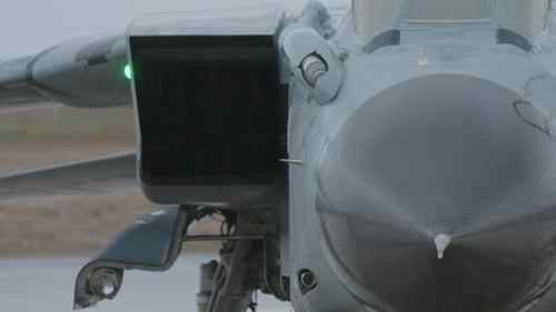 Close Up of Military Jet on Runway in Rain