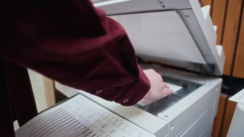 Hands of Man Using MFP to Make Copies of Documents at Office