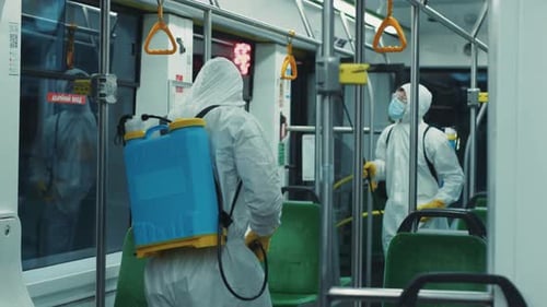 Workers in Protective Suits Sanitize Public Transportation