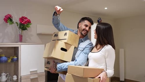 Happy Couple Moving into New Home with Boxes