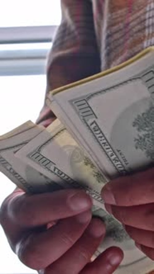 Person Counting Stack of Cash Money Currency