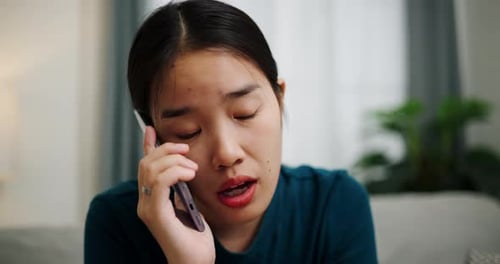 Emotional Woman Talking on Cell Phone Indoors