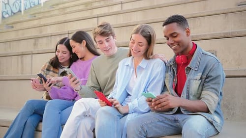 Friends Using Smartphones Together on City Steps