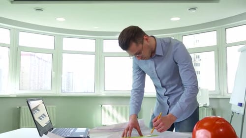 Confident Architect Engaged in Design Work at a Modern Office Desk