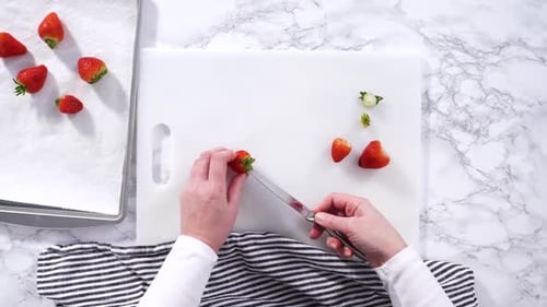 Fresh Strawberries Displayed on a White Cutting Board