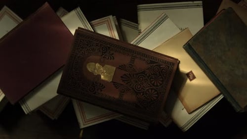 Top View of a Stack of Old Books on a Wooden Table