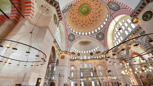 Interior view of the Suleymaniye mosque in Istanbul, Turkey. A lot of illumination, painted ceiling