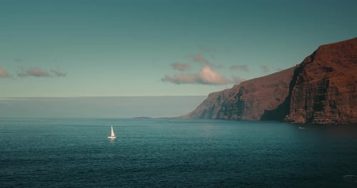 Lonely Yacht in Ocean Bay Near Mountains of Tenerife Canary Island Summer Vacation Scenery of Los