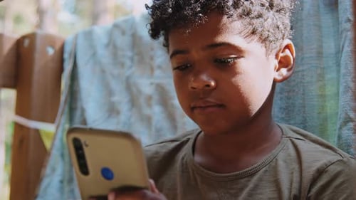 Child Using a Smartphone at Home During Daytime