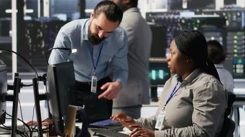 Tech Team Discussing Code in Server Room