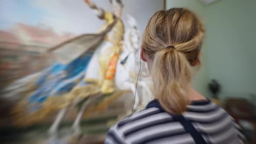 Enjoying Art in a Museum While Listening to an Audio Guide