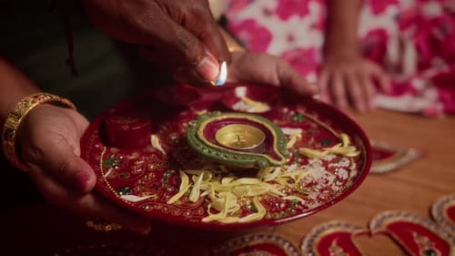 Lighting a Diya Lamp on Decorative Plate