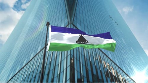 Lesotho Flag Waving on Modern Corporate Building