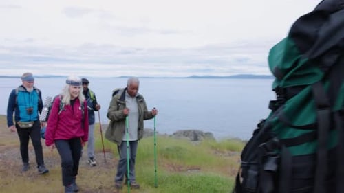 Happy Senior Friends Hing Walking on Cliff Above Ocean 5054 Years