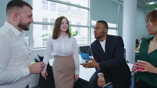 Diverse Team Having a Cheerful Office Conversation