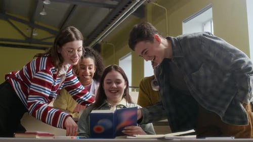 Peers Having Fun while Reading Book in Class in College