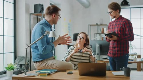Office Team Discussing Ideas in Modern Workspace