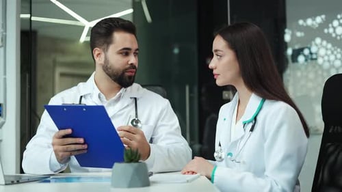 Doctors Discussing Medical Record in Modern Office