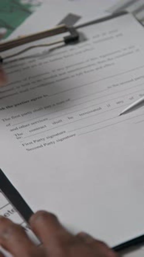 Signing a Contract on a Clipboard