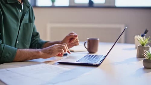 Man Working on Laptop, Cheering in Workplace