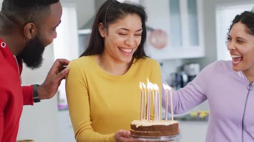 Friends Celebrate Birthday with Cake and Candles