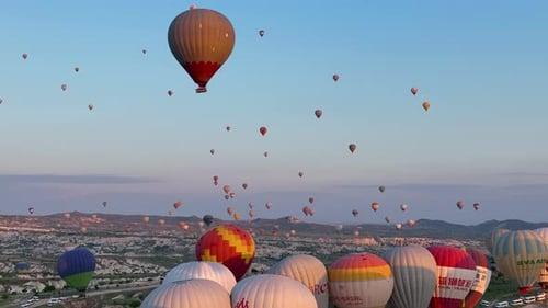 Hot Air Balloons Fly Over the Mountainous Landscape of Cappadocia Turkey
