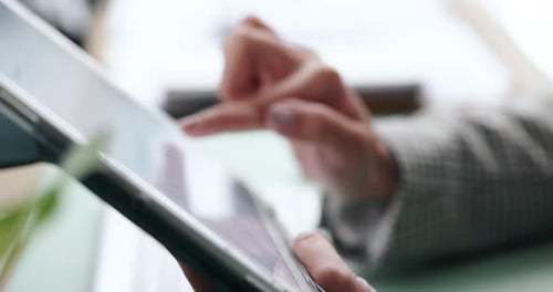 Hands Working on Tablet in Bright Workplace