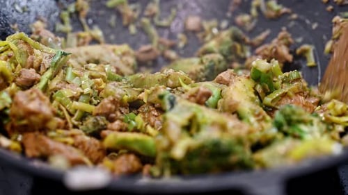 Cooking Meat and Vegetables in Pan with Spatula