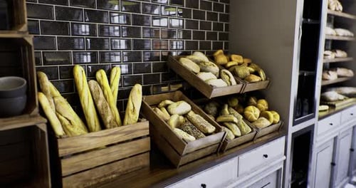 Freshly Baked Artisan Breads Displayed in Rustic Wooden Crates at a Cozy Bakery