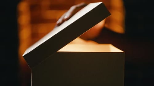 Opening Gift Box with Glowing Light in Dark