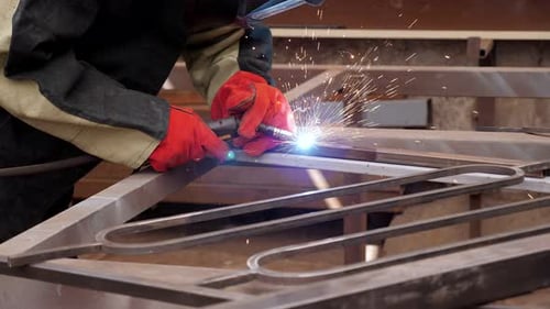 Metal Worker Welding Metal in a Workshop